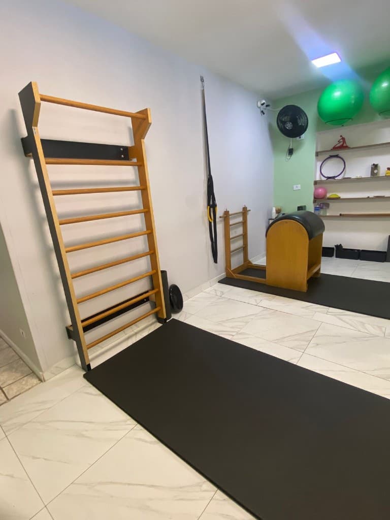 Sala de pilates com barras, ladder barrel e acessórios
